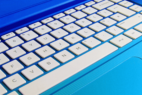 White keyboard on a blue laptop